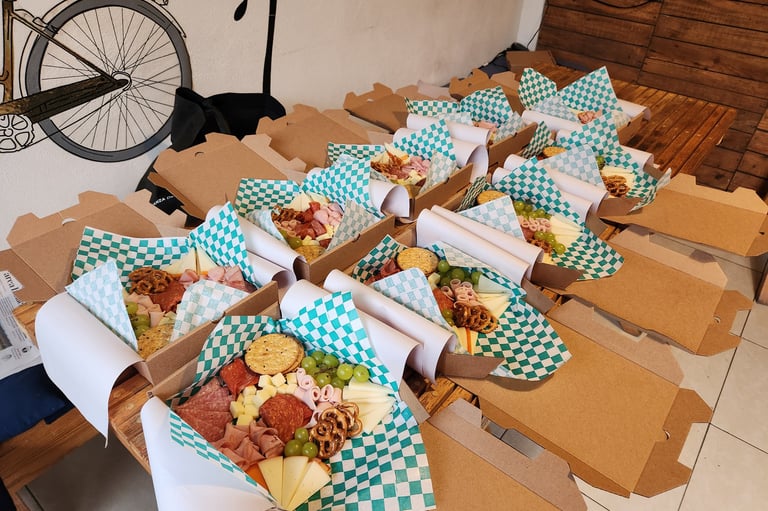 a table with boxes of charcuterie