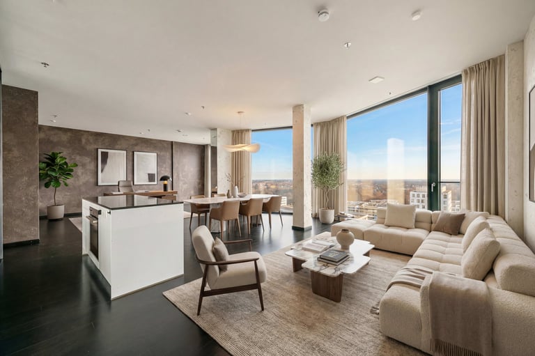 Luxury open-concept penthouse featuring a modern living room, dining area, and kitchen with panoramic city views.