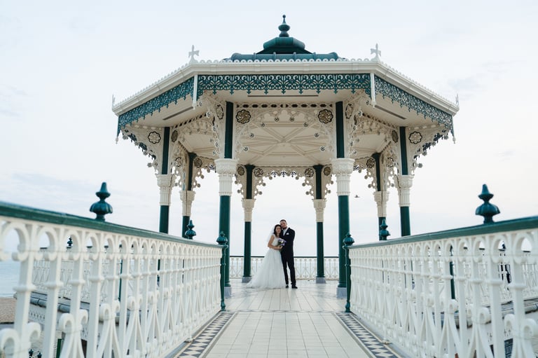 married couple holding hands by the sea