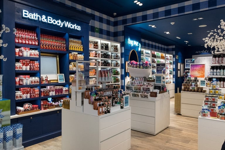 Interior view of a Bath & Body Works retail store featuring fragrance sprays, body lotions, and skincare displays.