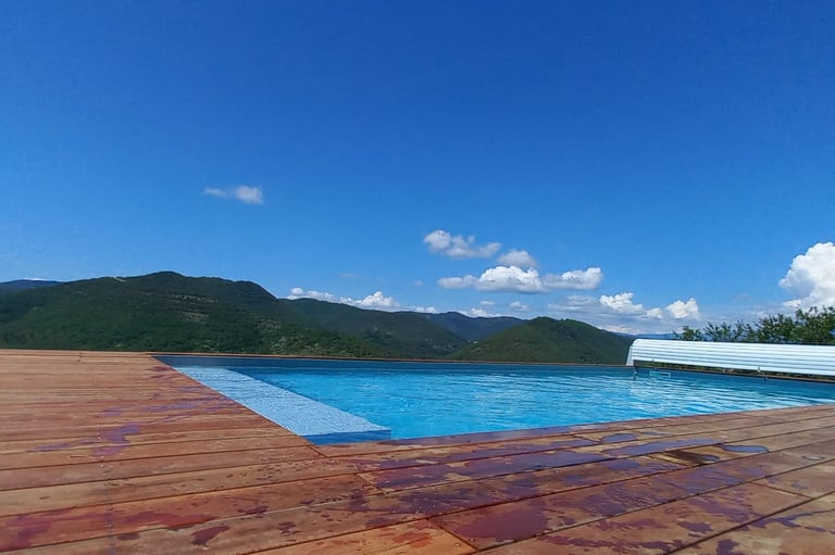 a pool with a bench and a bench in the background