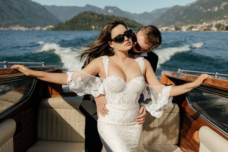 a woman in a white dress and sunglasses on a boat in Lake Como
