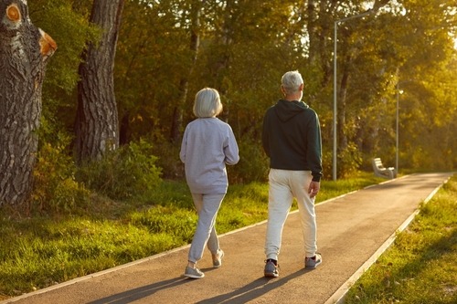 a man and woman walking down a path