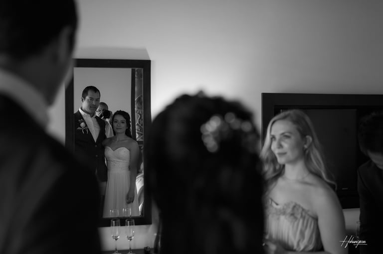 a man and woman standing in front of a mirror