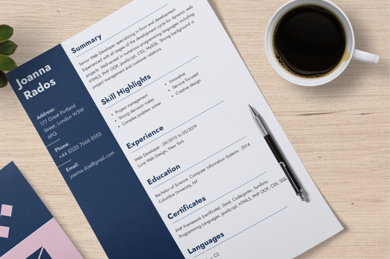 A CV resting on a table besides a cup of black coffee