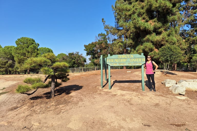 Janet with the Shinzen Friendship Garden Sign