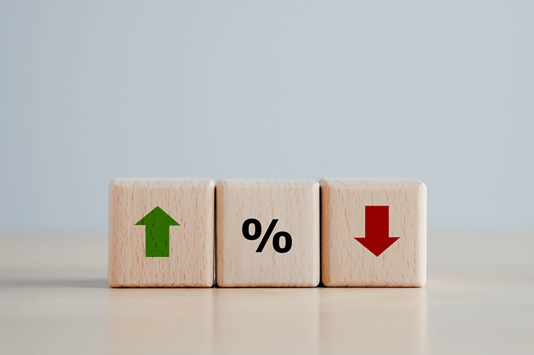 a wooden block with a percentage sign and arrows