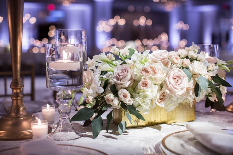 Floral centerpiece with tea light candles used to elevate the space.