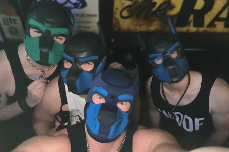 Four men in pup masks posing for picture