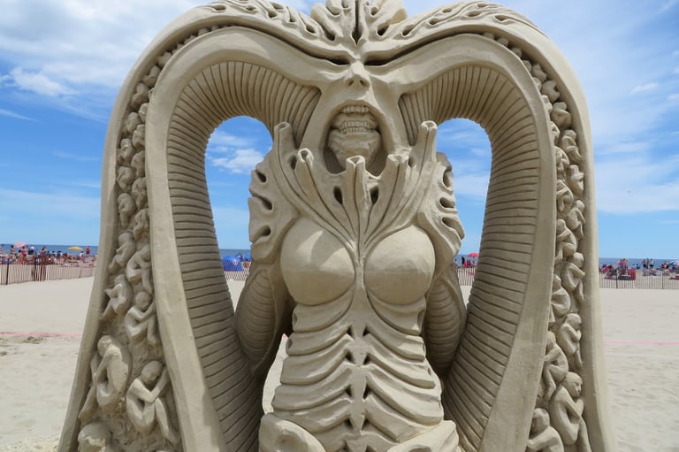 sand sculpture depicting a creature based on H.R. Giger artstyle