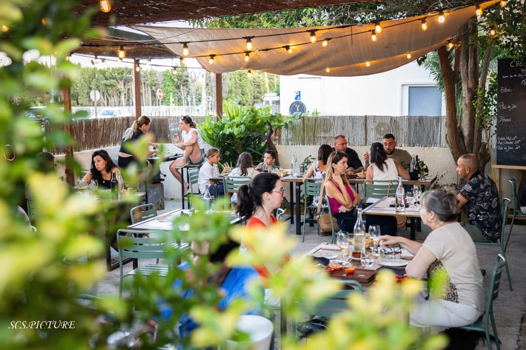 a group of people sitting at tables in a restaurant