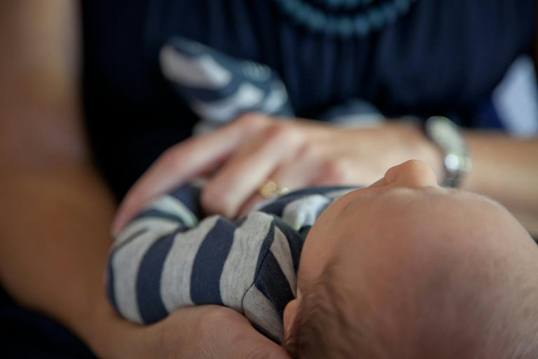 baby held by two hands