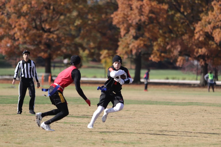 2 people playing flag football.