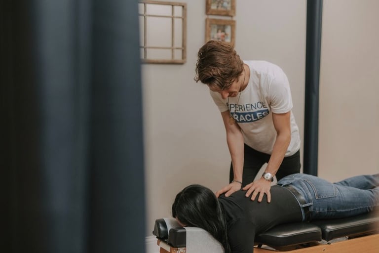 Pregnant woman receiving gentle prenatal chiropractic adjustment in Franklin TN