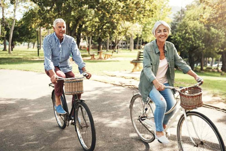 Older man and woman in a park in Carbondale, CO able to bike after peripheral neuropathy treatment