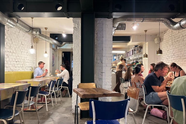Guests dining in cozy pizzeria