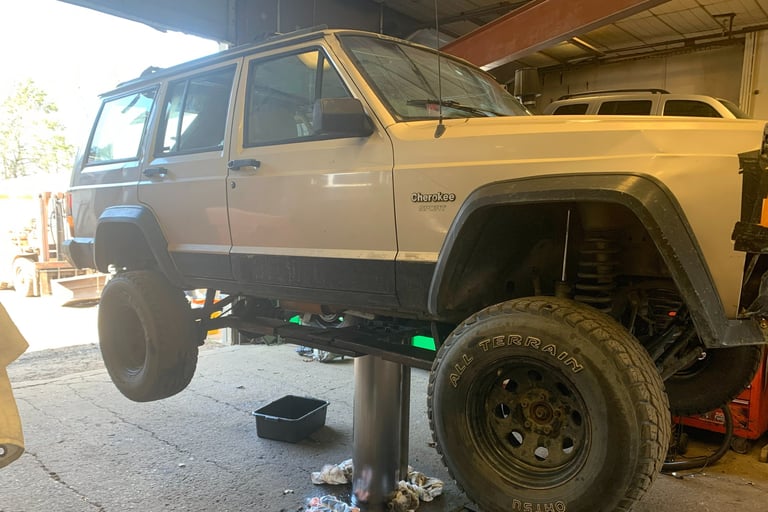 Suv on a lift in the middle of an oil change