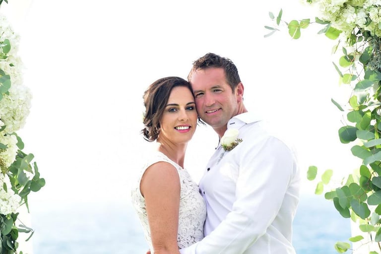 bride and groom standing under arch at wedding at cuvier park in La jolla