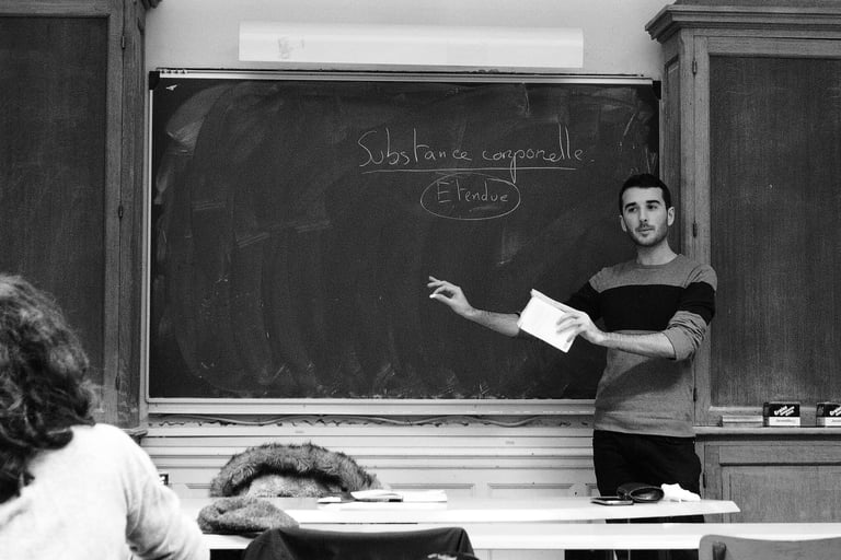 a man standing in front of a chalkboard with a blackboard
