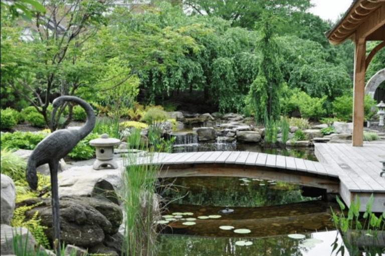 a statue of a crane standing on a wooden deck