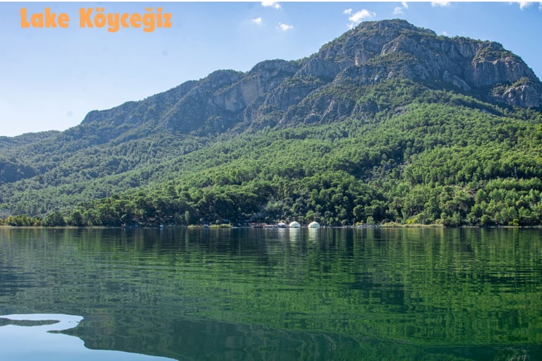 a mountain scene with a lake and a boat