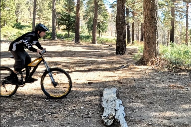 mountain biker preloading body to do the bump jump technique