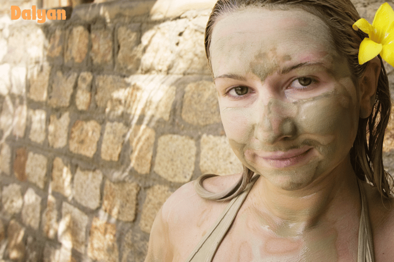 Mud bathing woman with a flower in her hair
