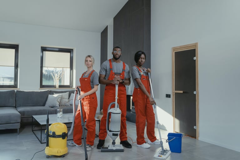 a group of people in orange overalls and overalls are standing in a room