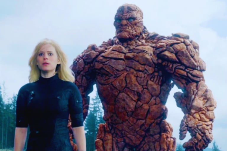 a woman in a black wetsuit standing next to a giant thing