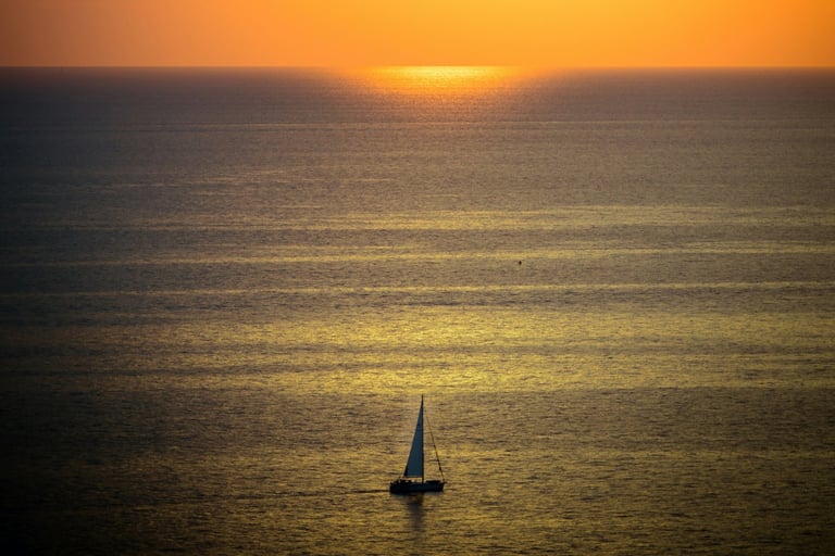 Boat sailing during a Greek sunset