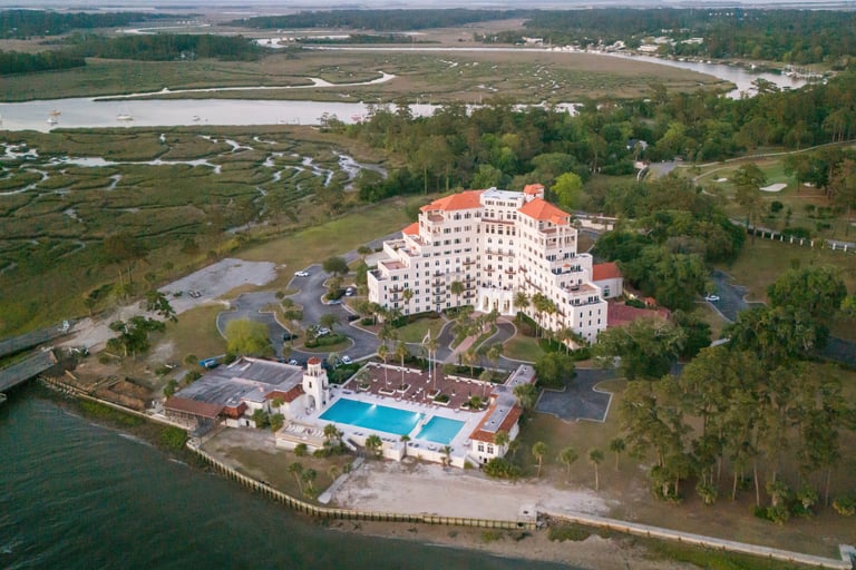 real estate drone photography of a condo complex on a river