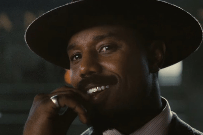 a man in a suit and tie is talking on a cell phone