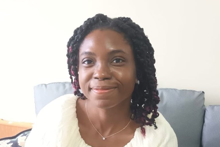 woman smiling with grey chair background