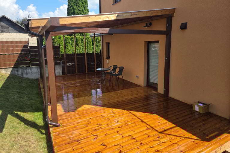 a patio with a wooden deck and a table with chairs
