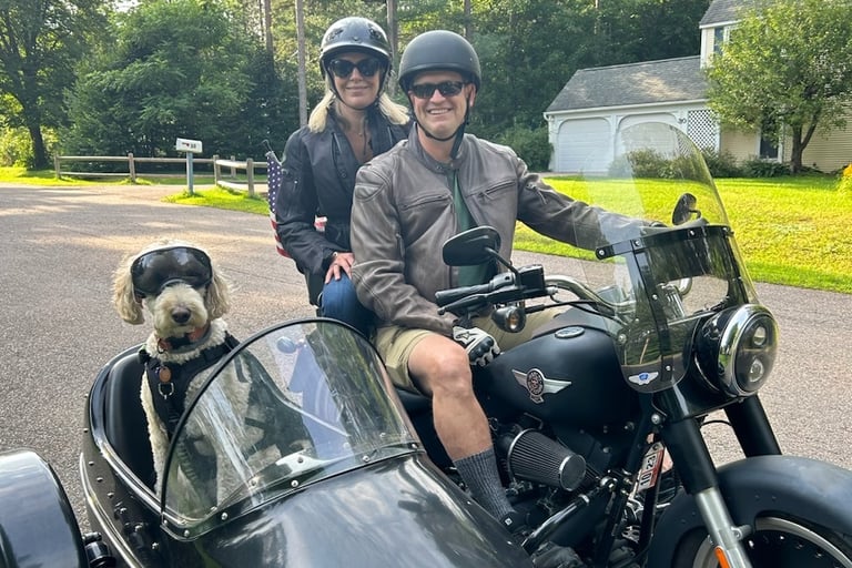 picture of Dr. Goslin, wife, and dog in a sidecar