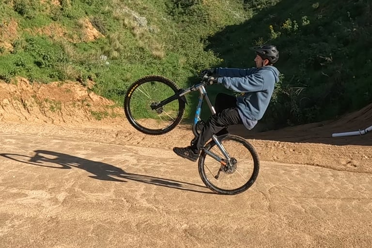 mountain biker in the balance point on a wheelie
