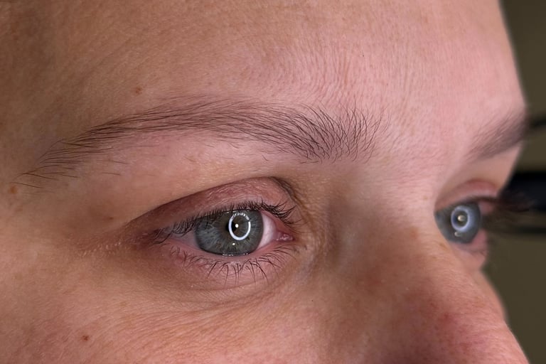 A woman with her current state of eyebrows before getting microblading procedure
