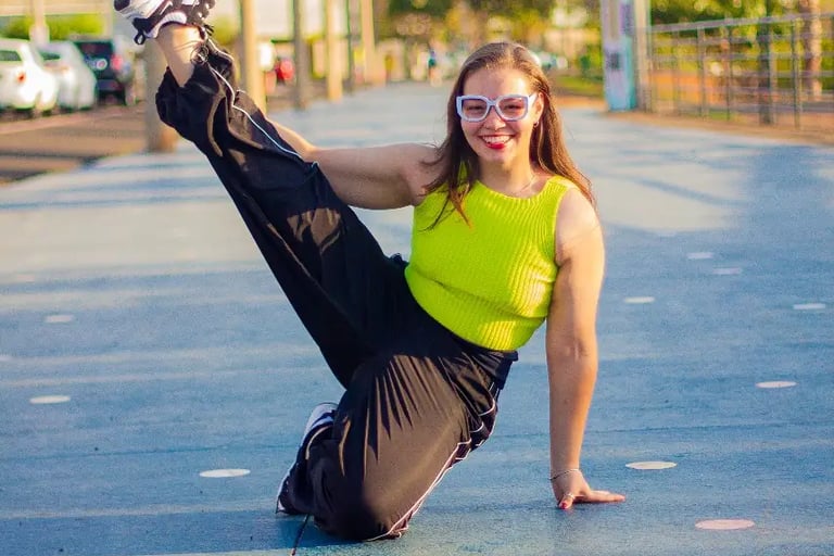 a woman in a neon green top and black pants