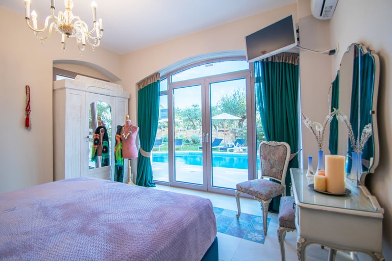 bedroom with queen size bed and a pool view