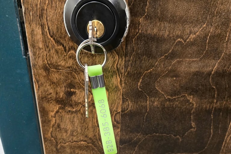 Wooden door with a key in the keyhole representing Jack’s Locksmith local rekeying services in Spruce Pine, NC
