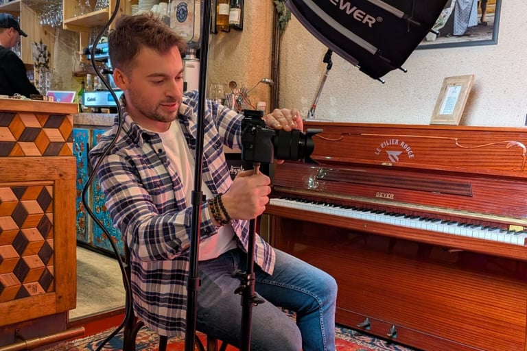 a man sitting in a chair with a camera and a camera