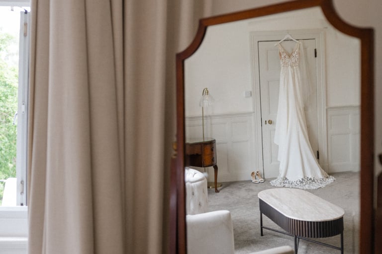 wedding dress hanging from a door frame at highley manor
