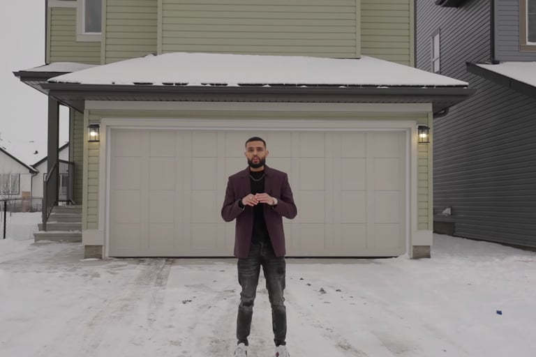 a man standing in front of a house in the snow