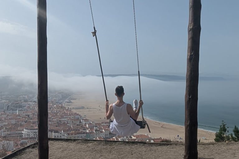 a man sitting on a swing set in a swing
