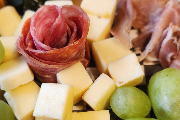 a plate of cheese and grapes on a plate