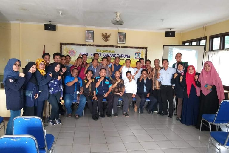 a group of people standing in front of a classroom