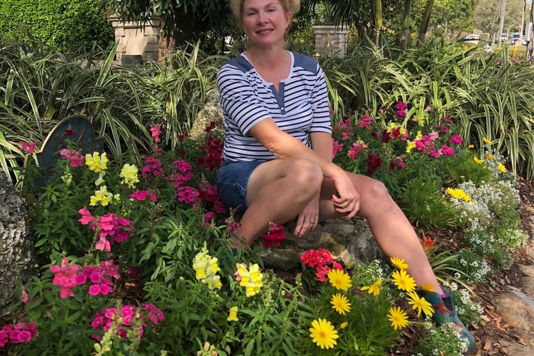 Melanie the owner sitting on a bench in a garden
