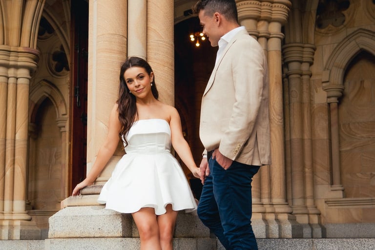 a man and woman standing on stairs in front of a building