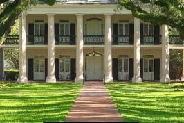 oak alley - a large house with a long driveway and a walkway