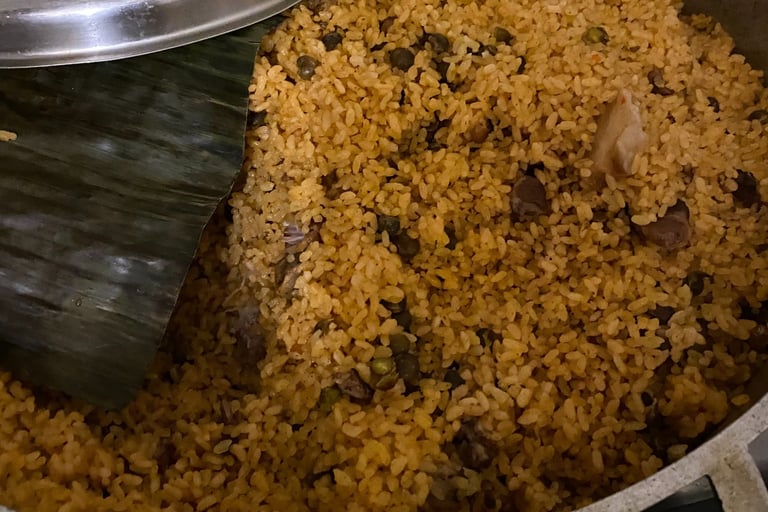 a pot of arroz con gandules with banana leaf